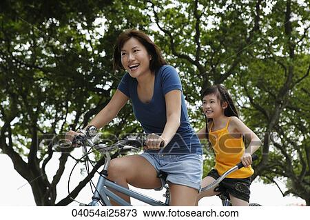 woman and young girl riding tandem bike View Large Photo Image Stock Image - woman and young girl riding tandem bike. Fotosearch