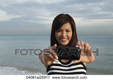 Young woman smiling through middle of inner tube View Large Photo Image Stock Photo - Young woman smiling through middle of inner tube. Fotosearch