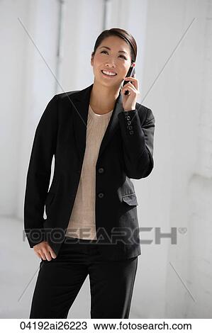 Businesswoman using phone, smiling View Large Photo Image Stock Image - Businesswoman using phone, smiling. Fotosearch