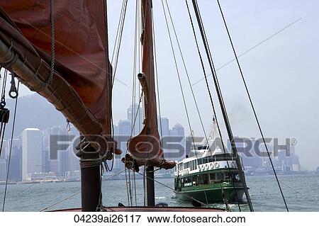 Chinese junk 'Duckling' at Victoria Harbour with the background of skyscrapers in Central & Star Ferry, Hong Kong View Large Photo Image Stock Photo - Chinese junk 'Duckling' at Victoria Harbour with the background of skyscrapers in Central & Star Ferry, Hong Kong. Fotosearch