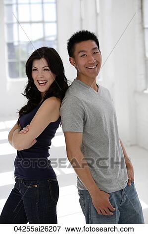 Couple leaning on each other, smiling View Large Photo Image Stock Photo - Couple leaning on each other, smiling. Fotosearch