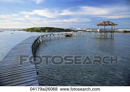 Stock Photo - Footbridge with a nipa house in the resort, Siargao, Philippines. Fotosearch