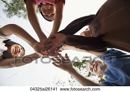 Four children grasping hands. View Large Photo Image Stock Image - Four children grasping hands.. Fotosearch