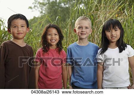 Four children standing together, smiling. View Large Photo Image Stock Image - Four children standing together, smiling.. Fotosearch