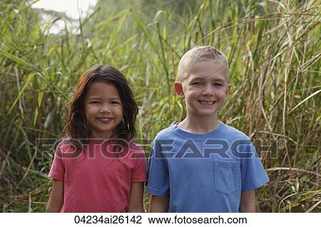 Girl and boy smiling at camera. View Large Photo Image Stock Image - Girl and boy smiling at camera.. Fotosearch