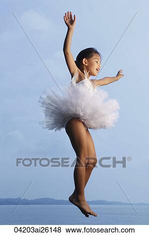 Stock Photo - Girl jumping in air wearing tutu.. Fotosearch