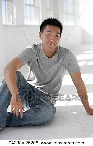 Man sitting casually on the floor View Large Photo Image Stock Photography - Man sitting casually on the floor. Fotosearch