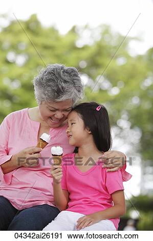 Older woman and young girl eating ice cream. View Large Photo Image Stock Image - Older woman and young girl eating ice cream.. Fotosearch