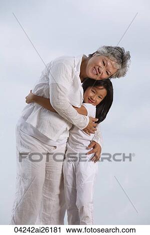 Older woman and young girl hugging. View Large Photo Image Stock Image - Older woman and young girl hugging.. Fotosearch