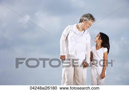 Older woman and young girl looking at each other. View Large Photo Image Stock Image - Older woman and young girl looking at each other.. Fotosearch