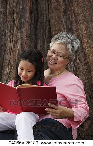 Older woman reading book with young girl. View Large Photo Image Stock Photo - Older woman reading book with young girl.. Fotosearch