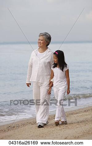 Stock Photo - Older woman walking with young girl.. Fotosearch