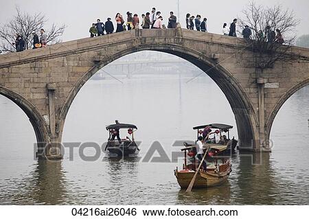 Tourists on excursion boats and on Fangsheng Bridge, Zhujiajiao, China View Large Photo Image Stock Photograph - Tourists on excursion boats and on Fangsheng Bridge, Zhujiajiao, China. Fotosearch