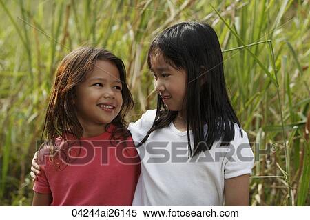 Two girls looking at each other. View Large Photo Image Stock Photography - Two girls looking at each other.. Fotosearch