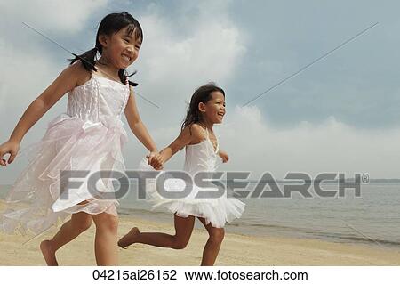 Two girls running together. View Large Photo Image Stock Image - Two girls running together.. Fotosearch