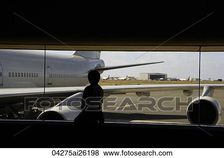 Young boy looking at airplane View Large Photo Image Stock Photo - Young boy looking at airplane. Fotosearch