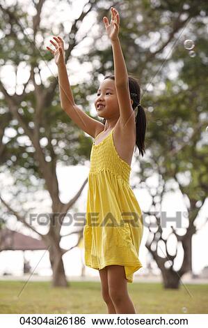 Young girl catching bubbles. View Large Photo Image Stock Photograph - Young girl catching bubbles.. Fotosearch