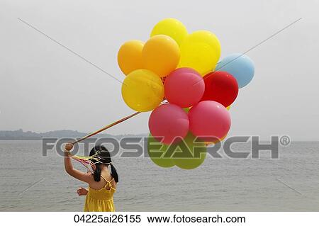 Young girl holding balloons. View Large Photo Image Stock Photography - Young girl holding balloons.. Fotosearch