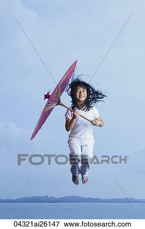 Young girl jumping with parasol View Large Photo Image Stock Photo - Young girl jumping with parasol. Fotosearch