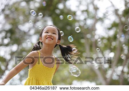 Young girl playing with bubbles. View Large Photo Image Stock Photo - Young girl playing with bubbles.. Fotosearch