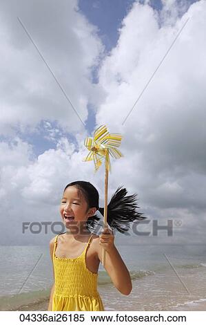 Young girl running with pinwheel. View Large Photo Image Stock Photography - Young girl running with pinwheel.. Fotosearch