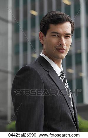 business man in a suit looking at camera View Large Photo Image Stock Image - business man in a suit looking at camera. Fotosearch