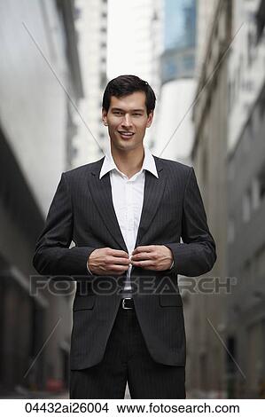 "businessman buttoning his suit jacket, smiling slightly" View Large Photo Image Picture - "businessman buttoning his suit jacket, smiling slightly". Fotosearch