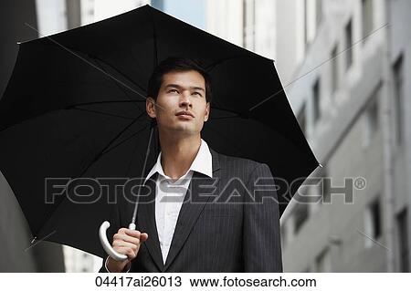 "businessman holding umbrella, looking up" View Large Photo Image Stock Image - "businessman holding umbrella, looking up". Fotosearch