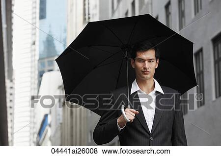 businessman holding umbrella View Large Photo Image Stock Photo - businessman holding umbrella. Fotosearch