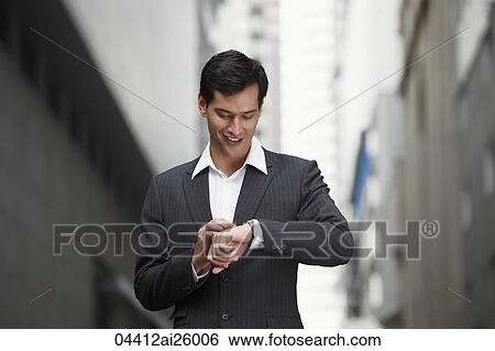 businessman looking at watch View Large Photo Image Stock Photograph - businessman looking at watch. Fotosearch