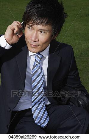 Businessman outside on cell phone View Large Photo Image Stock Photo - Businessman outside on cell phone. Fotosearch