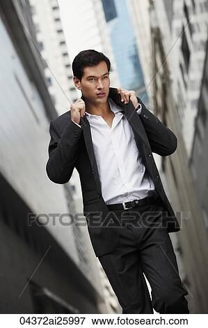 businessman pulling collar up View Large Photo Image Stock Photo - businessman pulling collar up. Fotosearch