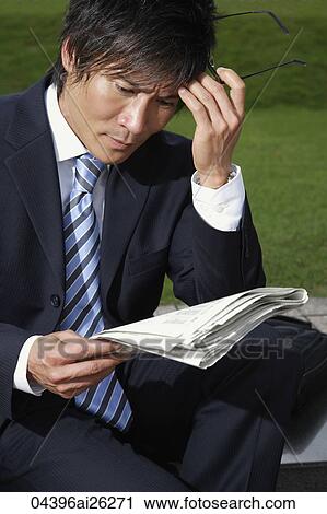 Businessman reading paper View Large Photo Image Stock Image - Businessman reading paper. Fotosearch