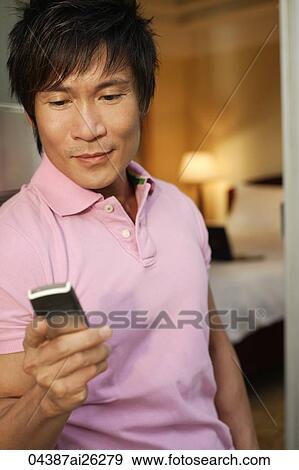 Man checking text messages View Large Photo Image Stock Photo - Man checking text messages. Fotosearch