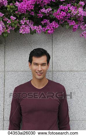 Stock Image - man in sweater smiling at camera. Fotosearch