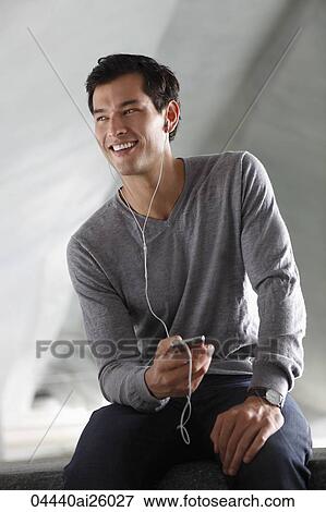 "man listening to music with earphones, smiling" View Large Photo Image Stock Photo - "man listening to music with earphones, smiling". Fotosearch