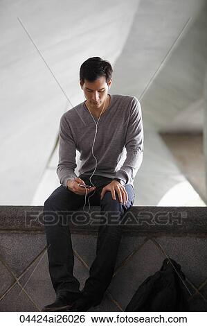 Stock Photograph - man listening to music with earphones. Fotosearch