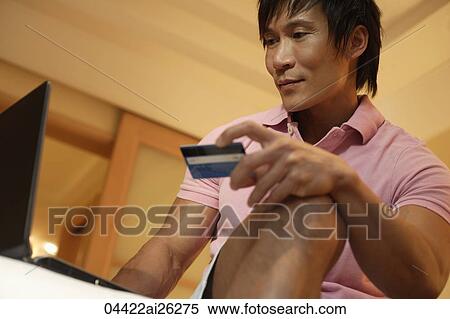 Man using credit card to shop online View Large Photo Image Stock Photography - Man using credit card to shop online. Fotosearch