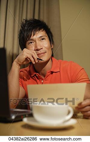 Stock Photograph - man working at table. Fotosearch