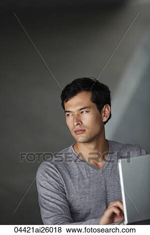 "man working on laptop, looking away" View Large Photo Image Stock Photo - "man working on laptop, looking away". Fotosearch