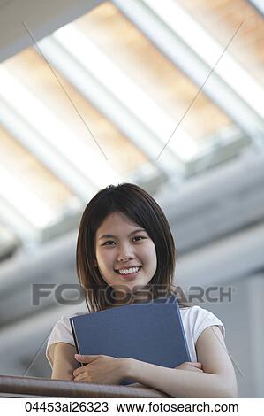 Stock Image - Chinese woman holding folder.. Fotosearch