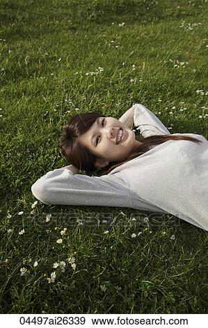 Chinese woman laying on grass relaxing. View Large Photo Image Stock Photo - Chinese woman laying on grass relaxing.. Fotosearch