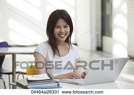 Chinese woman working on a laptop inside. View Large Photo Image Stock Image - Chinese woman working on a laptop inside.. Fotosearch