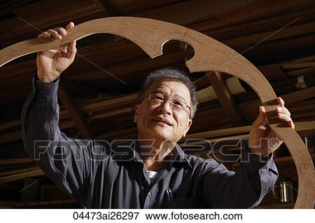 mature man looking at his creation View Large Photo Image Stock Photo - mature man looking at his creation. Fotosearch