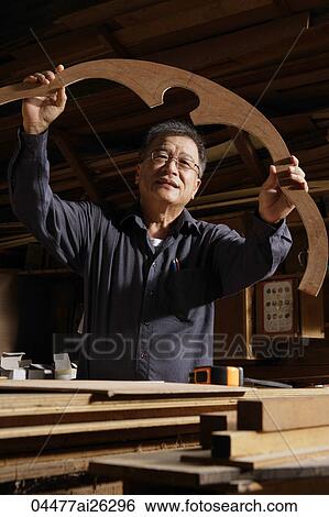 Mature man looking at his creation. View Large Photo Image Stock Photograph - Mature man looking at his creation.. Fotosearch