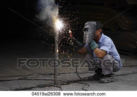Stock Photo - Mature man welding.. Fotosearch