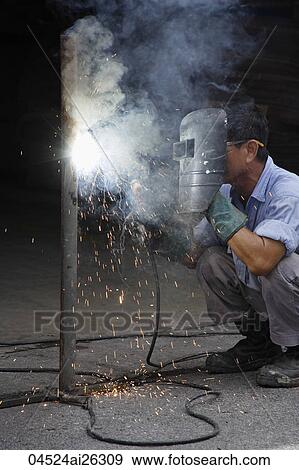 Stock Photo - Mature man welding.. Fotosearch