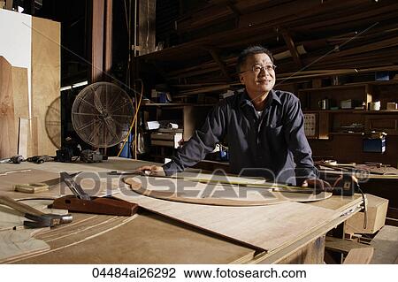 Stock Image - Mature man working in his wood shop.. Fotosearch