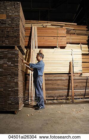 Mature man working in lumber yard. View Large Photo Image Picture - Mature man working in lumber yard.. Fotosearch