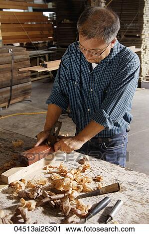 Mature man working with a block plane. View Large Photo Image Stock Image - Mature man working with a block plane.. Fotosearch
